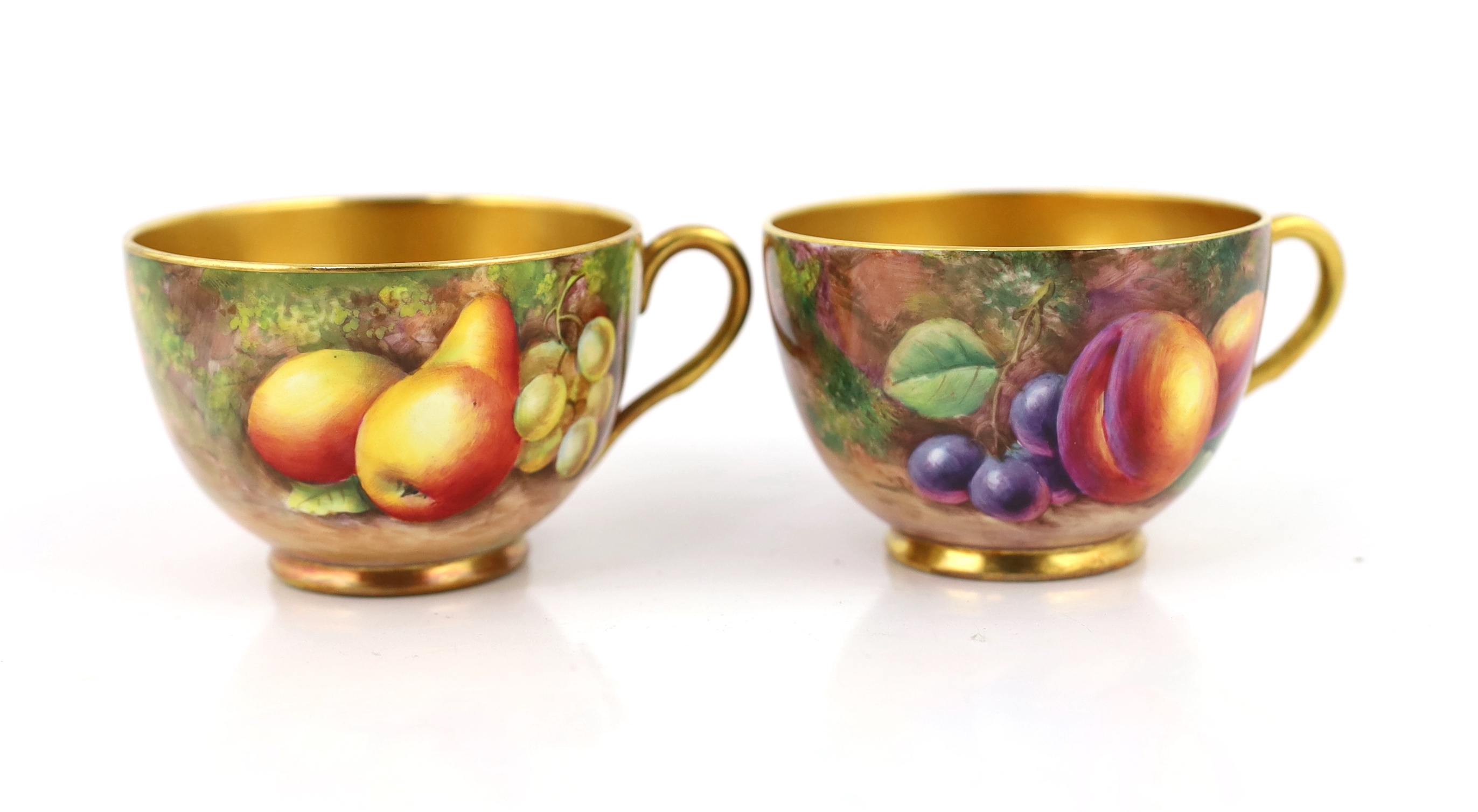 A pair of Royal Worcester fruit painted tea cups and saucers, 1960s